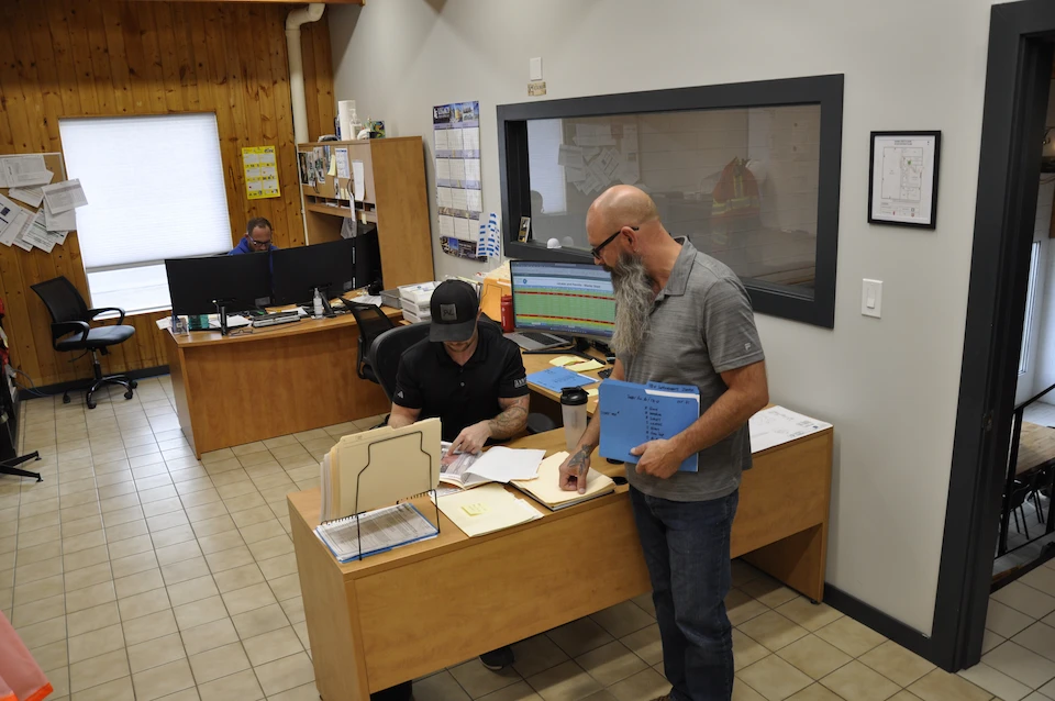 Project managers working in an office, analyzing documentation.